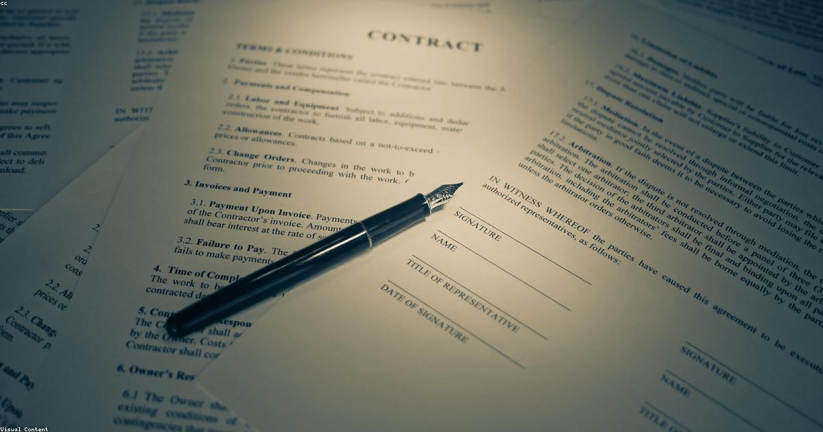 Resignation letter and employment documents on a desk in a UAE office